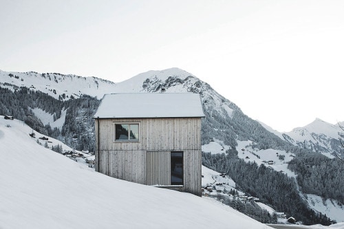Fontanella House is a minimalist house located in Fontanella, Austria, designed by Bernardo Bader. Not far from the center of the Walser village Fontanella in the Great Walser Valley, the house stands as a solitary volume on an inclined south-facing terrace. In order to both benefit from the wonderful views and limit the intervention of the property to the land, the house was well placed at the upper limit of the lot and tried to make the volume of the house as compact as possible. The outer skin of the entire building is made ​​of local pine boards in different widths. (5)