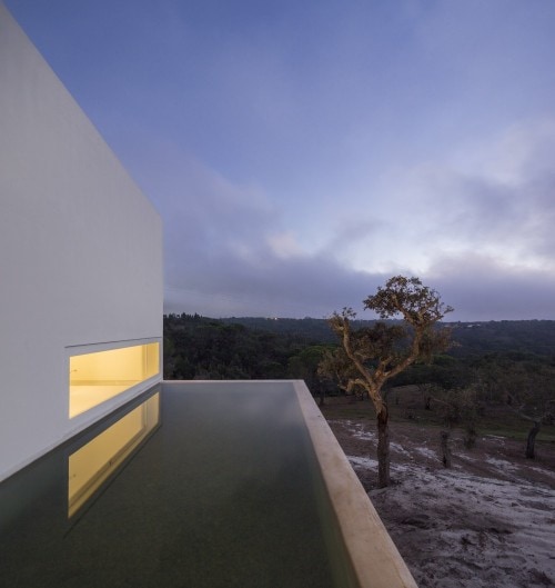 Casa en Fontinha is a minimalist house located in Melides, Portugal, designed by Manuel Aires Mateus. The design is centered around an open courtyard, which overlooks the beautiful landscape beyond. The minimalist white exterior facade is matched with an equally white and simple interior. (7)