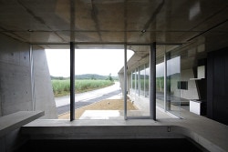Banna House is a minimalist design created by Japan-based designer Noriyoshi Morimura Architect & Associates. The concrete structure is characterized by its unique angular architecture. Appearing almost as a pavilion of sorts, panoramic windows span the length of the building to provide views of the mountain landscape. The interior is also constructed of the exposed concrete, and is juxtaposed against black walls. (13)