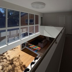 Cooks Hill Residence is a minimalist house located in Newcastle, Australia, designed by Bourne Blue Architecture. The building is located in a warm-climate region, and thus includes expansive windows that slide open to allow for the dining area to open up to the outside. The exterior is composed of wooden panels which coalesce with the patio and interior flooring. (12)