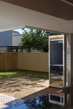Cooks Hill Residence is a minimalist house located in Newcastle, Australia, designed by Bourne Blue Architecture. The building is located in a warm-climate region, and thus includes expansive windows that slide open to allow for the dining area to open up to the outside. The exterior is composed of wooden panels which coalesce with the patio and interior flooring. (4)
