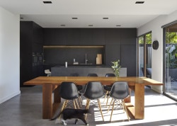 M House is a minimalist house located in Melbourne, Australia, designed by DKO. The kitchen space features blacked out custom cabinetry with a black kitchen island that allows for seating and serving. (8)