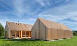 Timber House is a minimalist house located in Bavaria, Germany, designed by KÜHNLEIN Architektur. Two gabled structures are unified with wooden lattices: one containing living spaces and the other a series of bedrooms. (10)